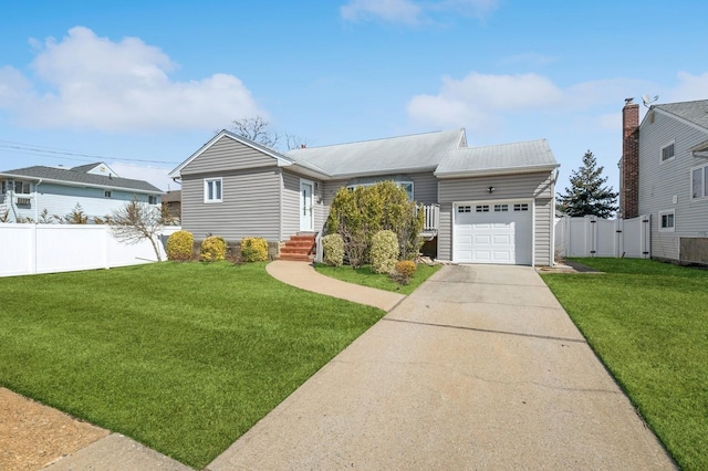 view of front of house featuring an attached garage, concrete driveway, a front yard, and fence