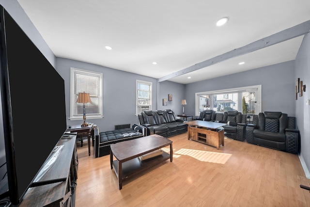 living area with beamed ceiling, recessed lighting, light wood-style floors, and a healthy amount of sunlight