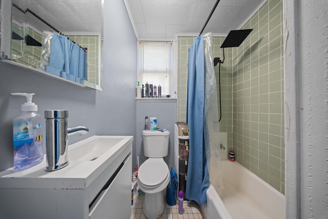 bathroom featuring tile patterned flooring, toilet, vanity, and shower / bath combo with shower curtain