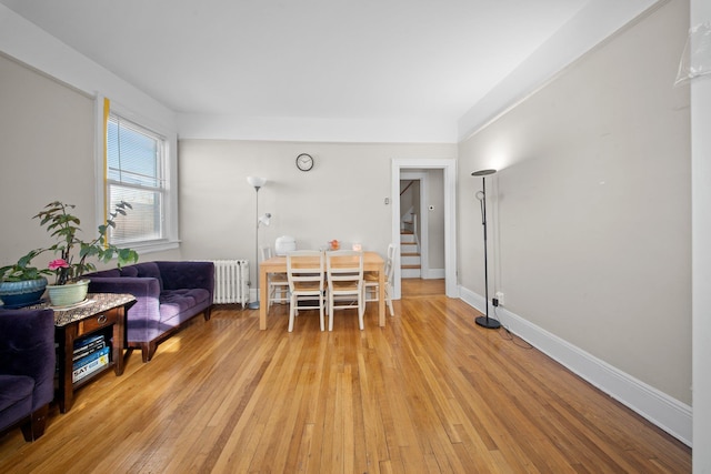 interior space with stairway, radiator, light wood-type flooring, and baseboards