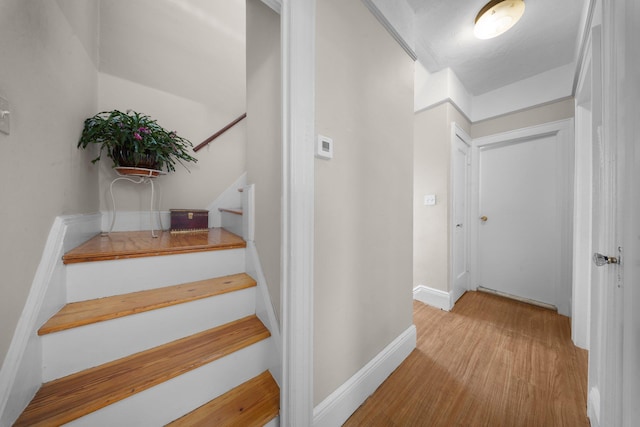 stairs featuring baseboards and wood finished floors