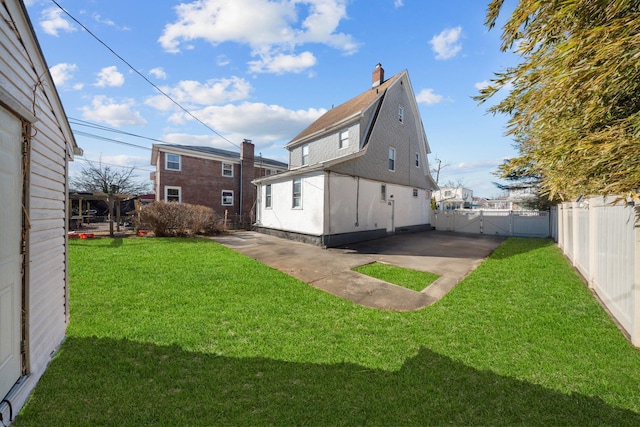 rear view of property with a yard, a patio, a fenced backyard, and stucco siding