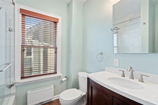 full bath featuring a wealth of natural light, radiator, vanity, and toilet