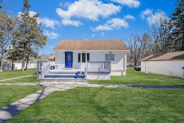 bungalow-style house featuring a front yard and a shingled roof