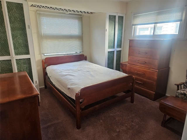 bedroom with dark colored carpet