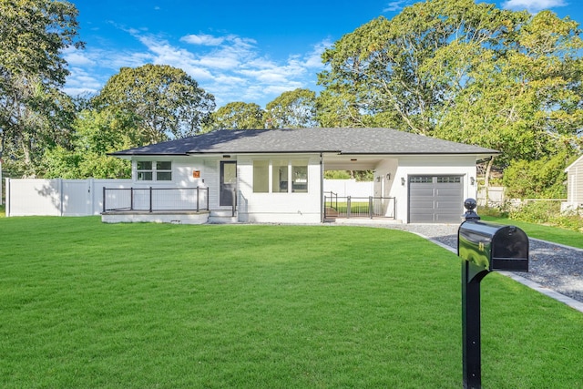 view of front of house with driveway, a front yard, and fence