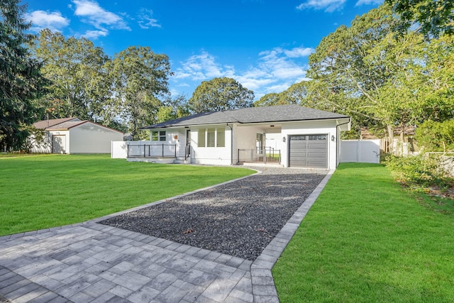 ranch-style home with stucco siding, driveway, fence, a front yard, and a garage