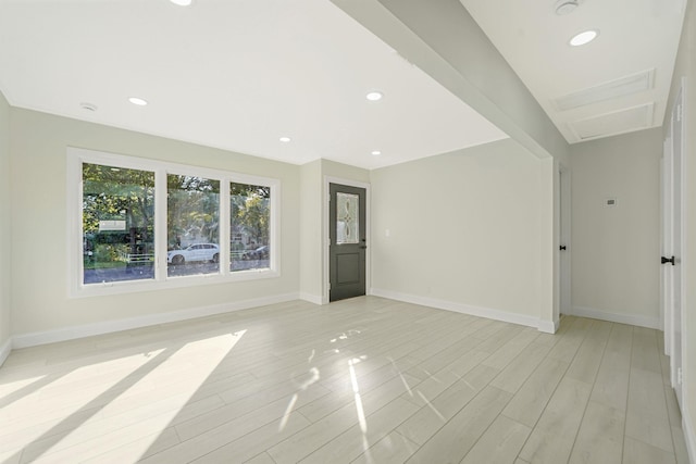 empty room with recessed lighting, baseboards, and light wood-style floors