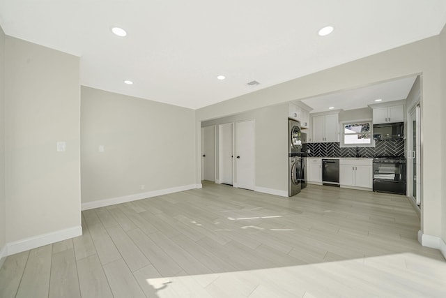 unfurnished living room with visible vents, baseboards, and light wood-style floors