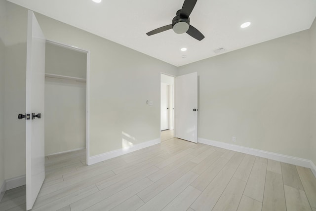 unfurnished bedroom featuring visible vents, baseboards, light wood-type flooring, recessed lighting, and a closet