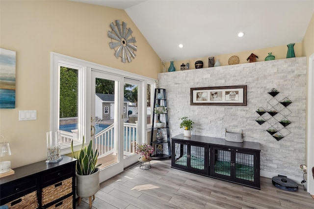 interior space with high vaulted ceiling and wood finished floors