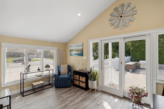 doorway featuring light wood-style flooring, recessed lighting, baseboard heating, and high vaulted ceiling