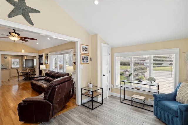 living room featuring recessed lighting, baseboards, light wood finished floors, and vaulted ceiling