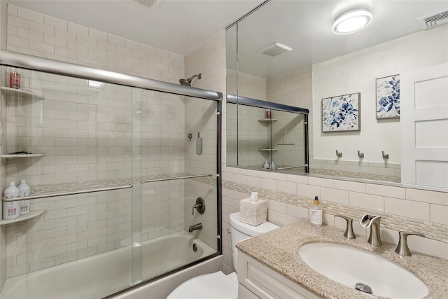 full bathroom featuring bath / shower combo with glass door, toilet, visible vents, and backsplash