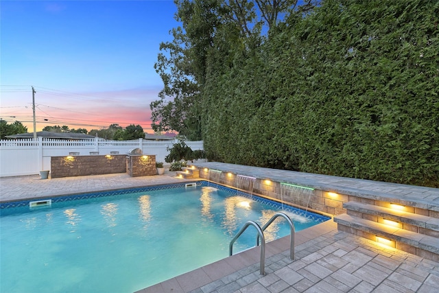 view of swimming pool featuring a fenced in pool, a patio, and a fenced backyard