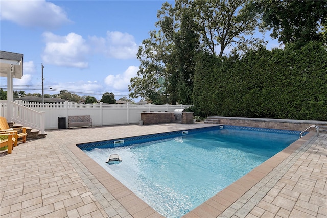 view of swimming pool featuring a patio, a fenced backyard, and a fenced in pool