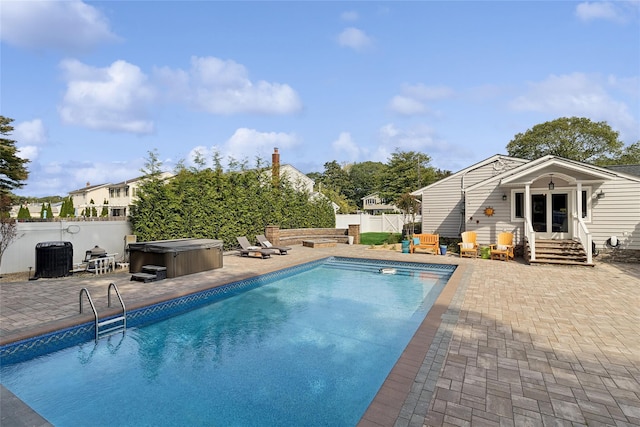 view of swimming pool with a patio area, a fenced in pool, a fenced backyard, and a hot tub