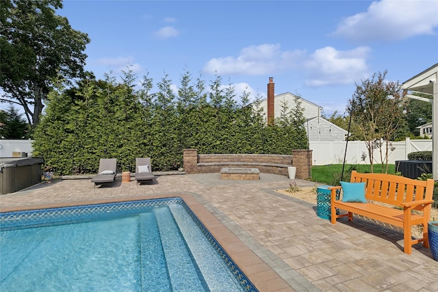 view of pool featuring a patio area, a fenced in pool, a hot tub, and a fenced backyard