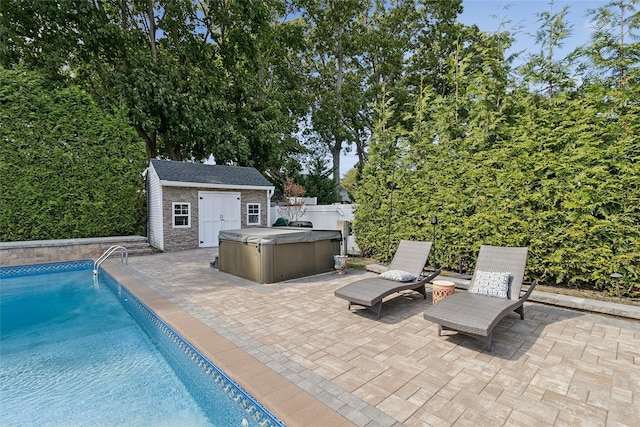 view of swimming pool featuring an exterior structure, a hot tub, fence, an outbuilding, and a patio