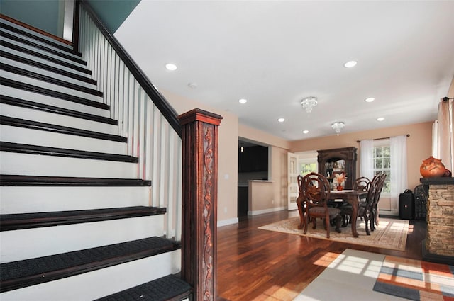 staircase with recessed lighting, baseboards, and wood finished floors