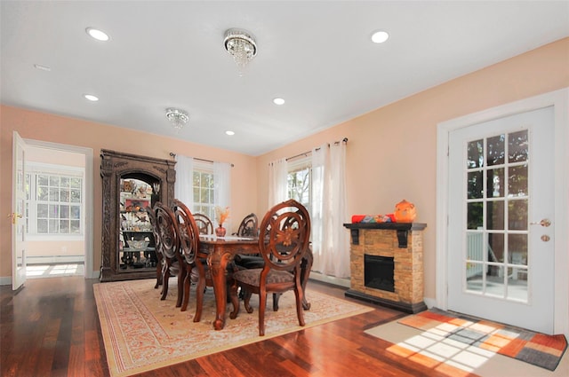 dining area with recessed lighting, a baseboard heating unit, and wood finished floors