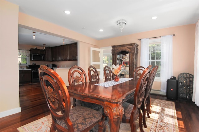 dining space with recessed lighting, dark wood-style floors, and baseboards