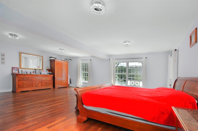 bedroom featuring baseboards and wood finished floors