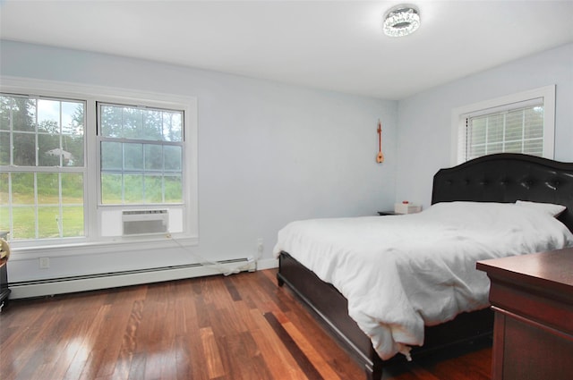 bedroom featuring baseboard heating, multiple windows, cooling unit, and wood finished floors