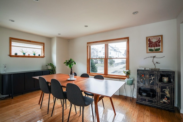 dining room with recessed lighting and light wood-style flooring