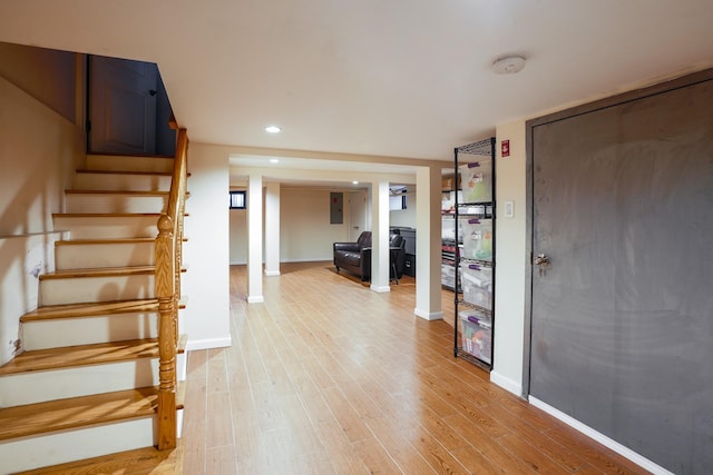 foyer entrance featuring recessed lighting, baseboards, stairs, and light wood finished floors