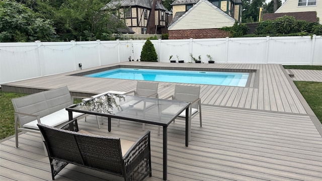 view of pool featuring a deck, a fenced in pool, and a fenced backyard