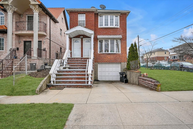 view of front of house with a front yard, brick siding, an attached garage, and driveway