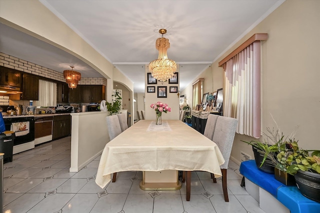 dining space featuring arched walkways, light tile patterned floors, crown molding, and an inviting chandelier