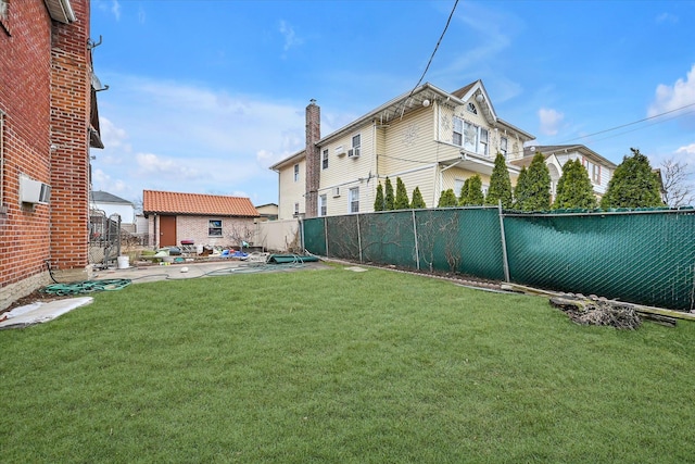 view of yard featuring an outbuilding, a patio, and a fenced backyard