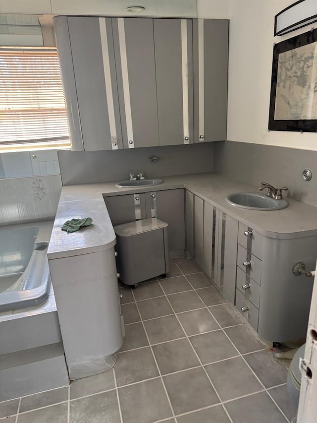 bathroom with tile patterned floors and vanity