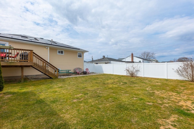 view of yard featuring a wooden deck, stairway, a fenced backyard, and a patio area