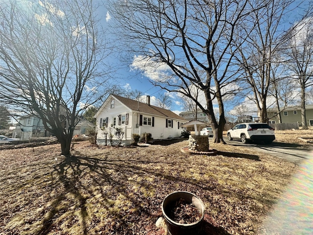 view of side of home featuring a chimney