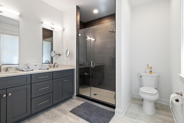 full bathroom with a sink, baseboards, double vanity, and a shower stall