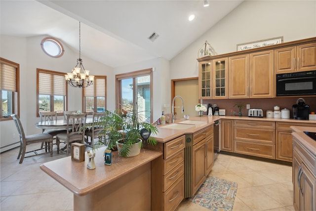 kitchen featuring visible vents, a sink, light tile patterned flooring, light countertops, and glass insert cabinets