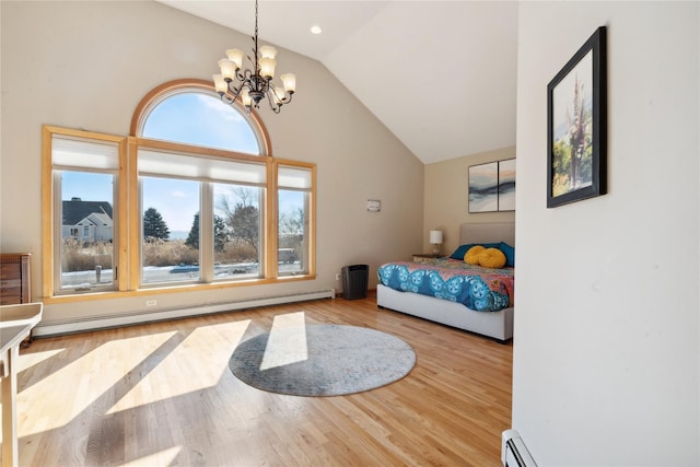 bedroom featuring a baseboard radiator, a chandelier, wood finished floors, and vaulted ceiling