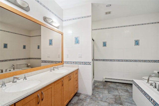 full bathroom with tile walls, a baseboard radiator, and a sink