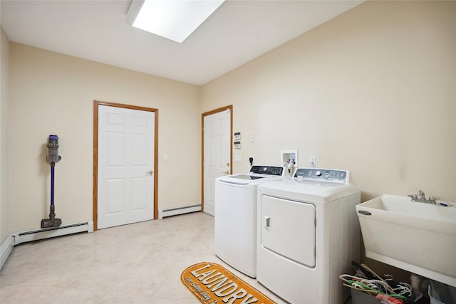 laundry room featuring washer and dryer, laundry area, baseboard heating, and a sink