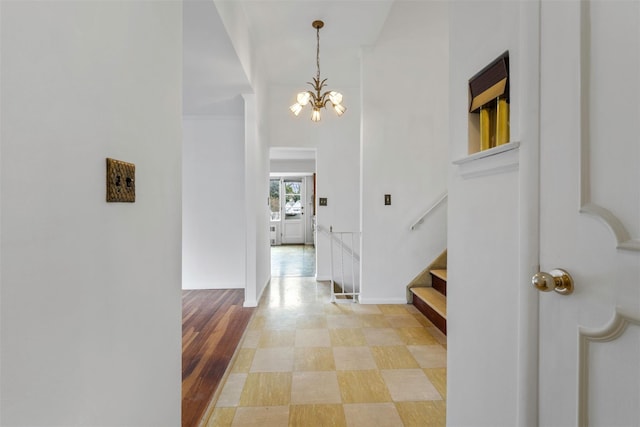 entrance foyer featuring stairway and an inviting chandelier