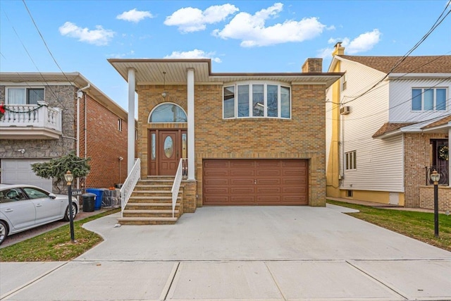 view of front of home featuring brick siding, driveway, an attached garage, and a chimney