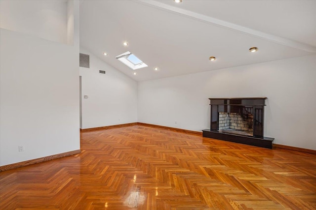 unfurnished room featuring baseboards, high vaulted ceiling, a fireplace with raised hearth, and a skylight