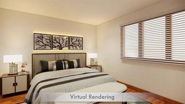 bedroom featuring wood finished floors and baseboards