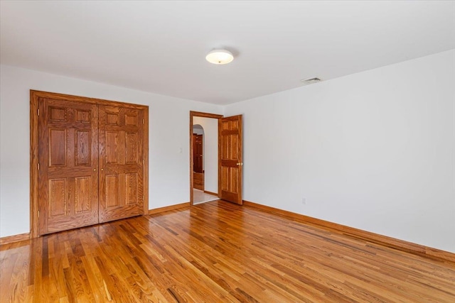 unfurnished bedroom featuring baseboards and light wood-style floors