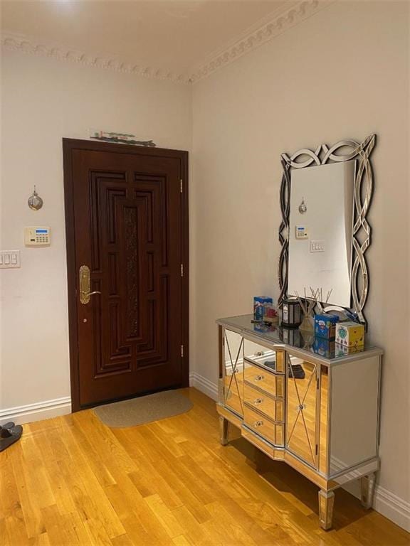 foyer featuring baseboards and light wood finished floors