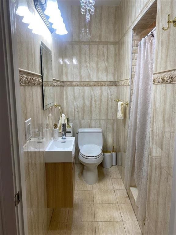 bathroom with vanity, tile patterned floors, toilet, and a shower with curtain