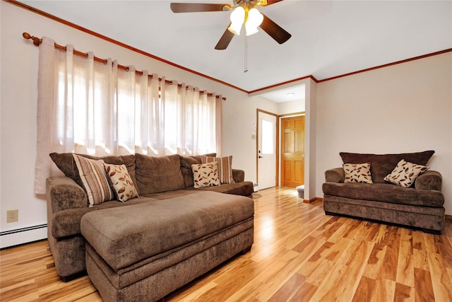 living area featuring a ceiling fan, crown molding, light wood-style floors, and a baseboard radiator